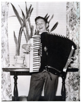 Bob playing the accordion 1953